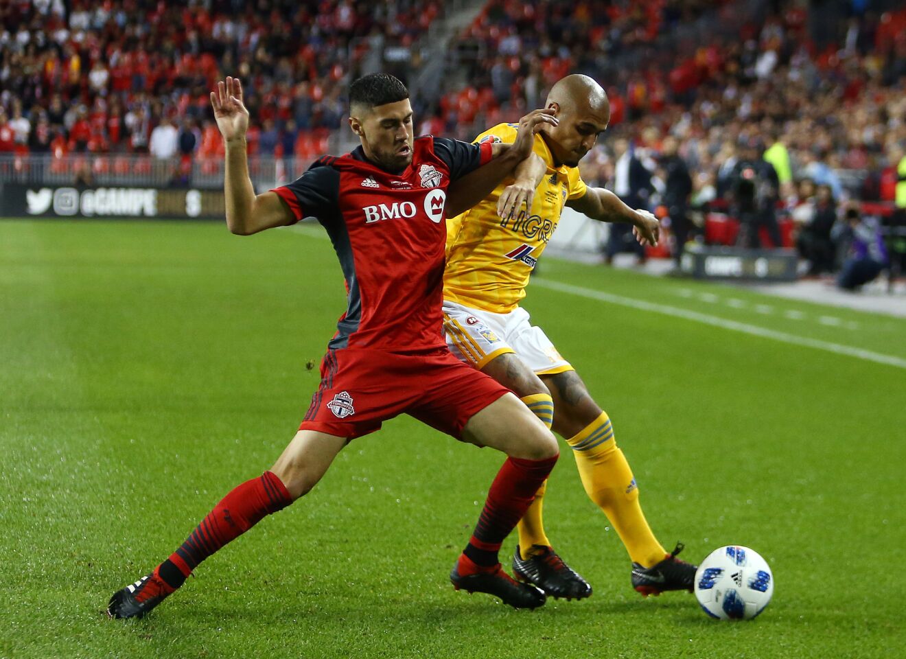 TORONTO, ON - SEPTEMBER 19: Luis Rodríguez #28 of Tigres UANL battles for the ball with Jonathan Osorio #21 of Toronto FC during the first half of the 2018 Campeones Cup Final at BMO Field on September 19, 2018 in Toronto, Canada. (Photo by Vaughn Ridley/Getty Images) ** OUTS - ELSENT, FPG, CM - OUTS * NM, PH, VA if sourced by CT, LA or MoD **