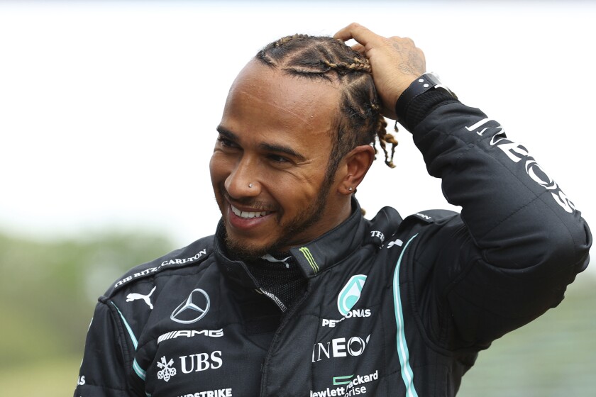 Mercedes driver Lewis Hamilton of Britain smiles after taking the fastest time during qualifying practice for Sunday's Emilia Romagna Formula One Grand Prix, at the Imola track, Italy, Saturday, April 17, 2021. (Bryn Lennon/Pool photo via AP)