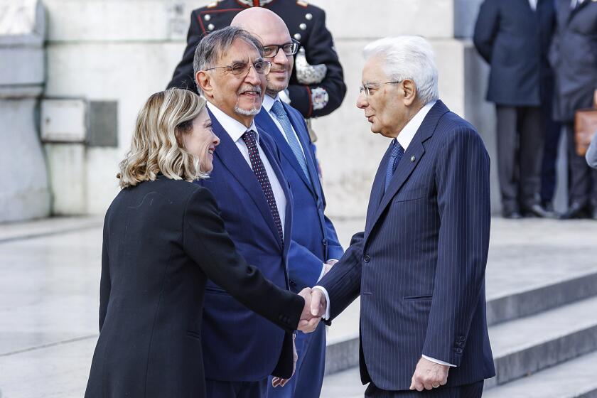 Italy's Prime Minister Giorgia Meloni shakes hands with the president of the Republic Sergio Mattarella during a ceremony at the Altar of the Fatherland for the 79th anniversary of the Liberation Day that commemorates the victory of the Italian resistance movement against Nazi Germany and the Italian Social Republic. in Rome, Thursday, April 25, 2024. (Roberto Monaldo/LaPresse via AP)