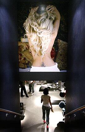 Oversize photos, such as the one of model-actress Rachel Hunters back, decorate the walls of Joint, a boutique gym in Hollywood. The stairs lead down to a small, dark private-training room.