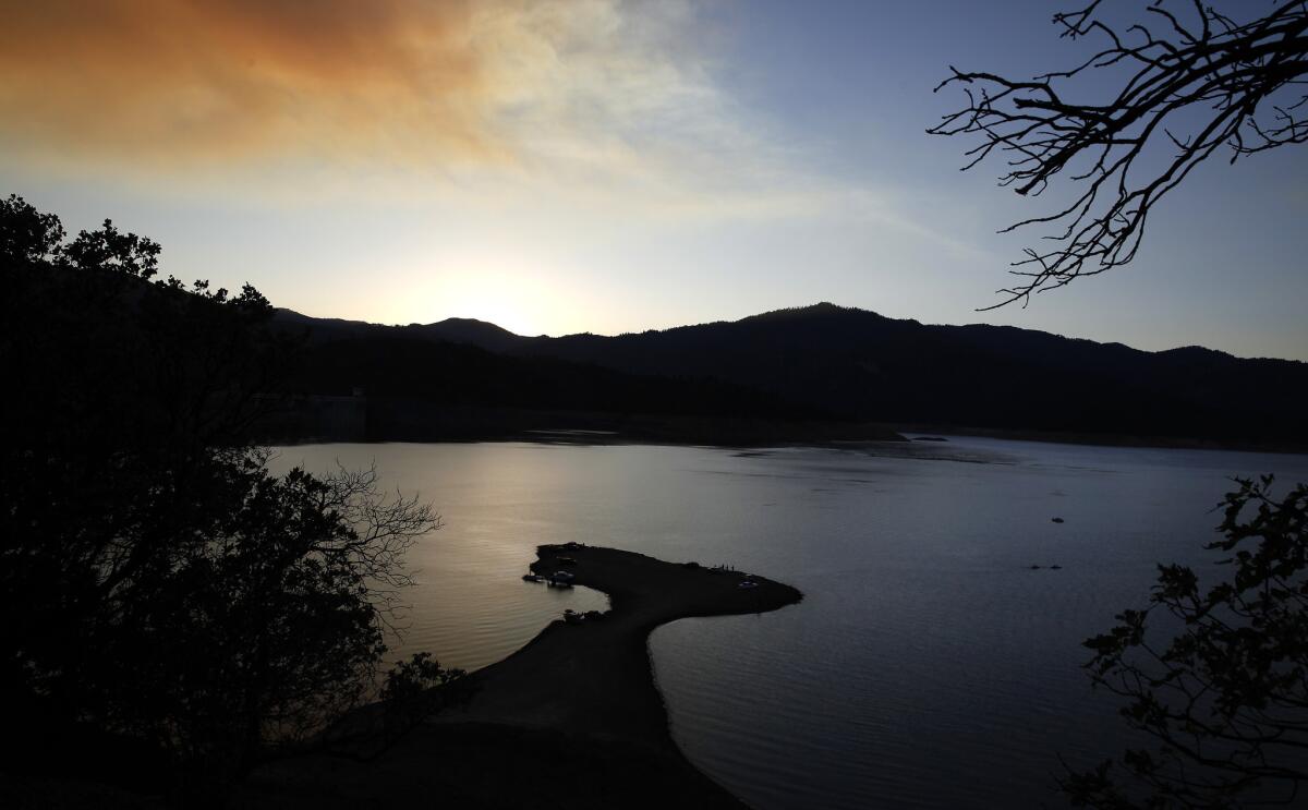 Boaters and fisherman take advantage of a newly exposed peninsula jutting out into the water on the receding shores of Lake Shasta near Redding, Calif. in July.