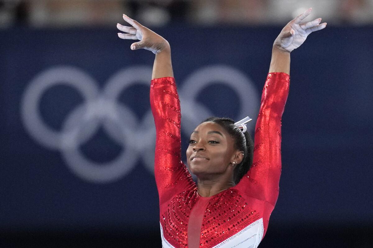 U.S. gymnast Simone Biles raises her arms and smiles