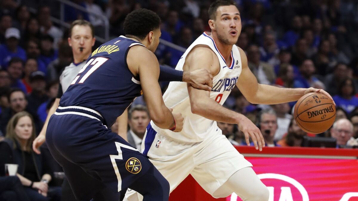 Clippers forward Danilo Galinari drives to the basket against Nuggets guard Jamal Murray in the second quarter Wednesday night at Staples Center.
