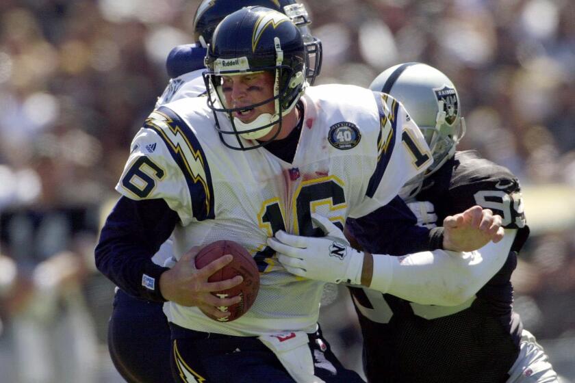 San Diego Chargers quarterback Ryan Leaf is sacked by Oakland Raiders defensive end Josh Taves during a Sept. 3, 2000, game in Oakland.