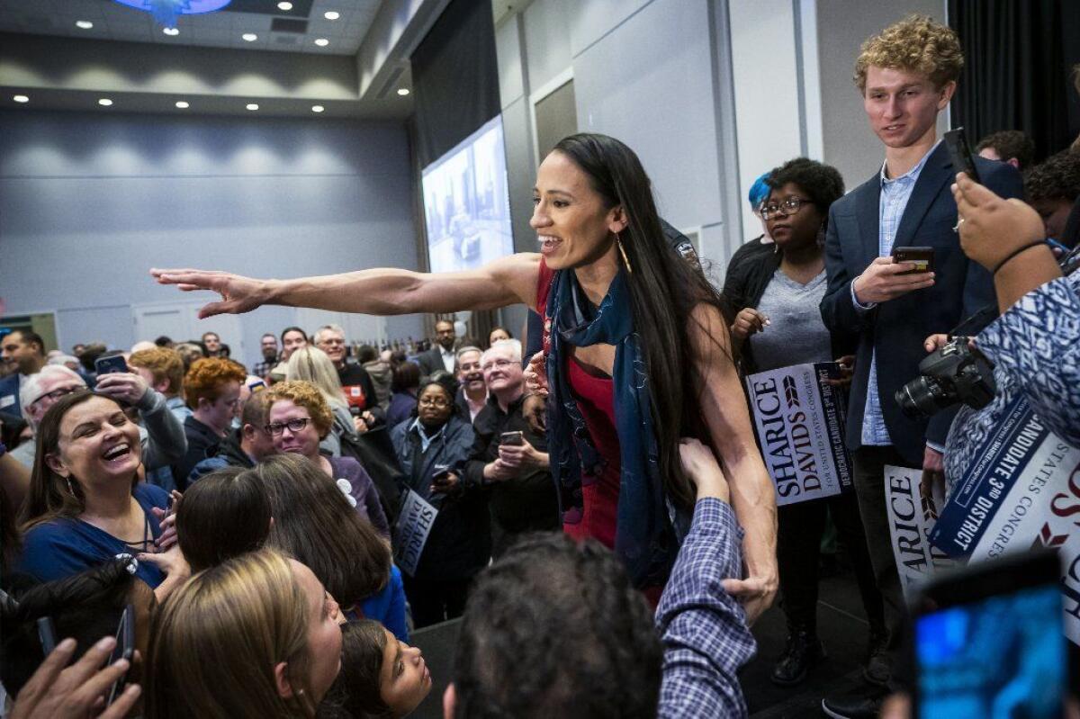 Congresswoman Sharice Davids celebrates after winning her race in 2018. 