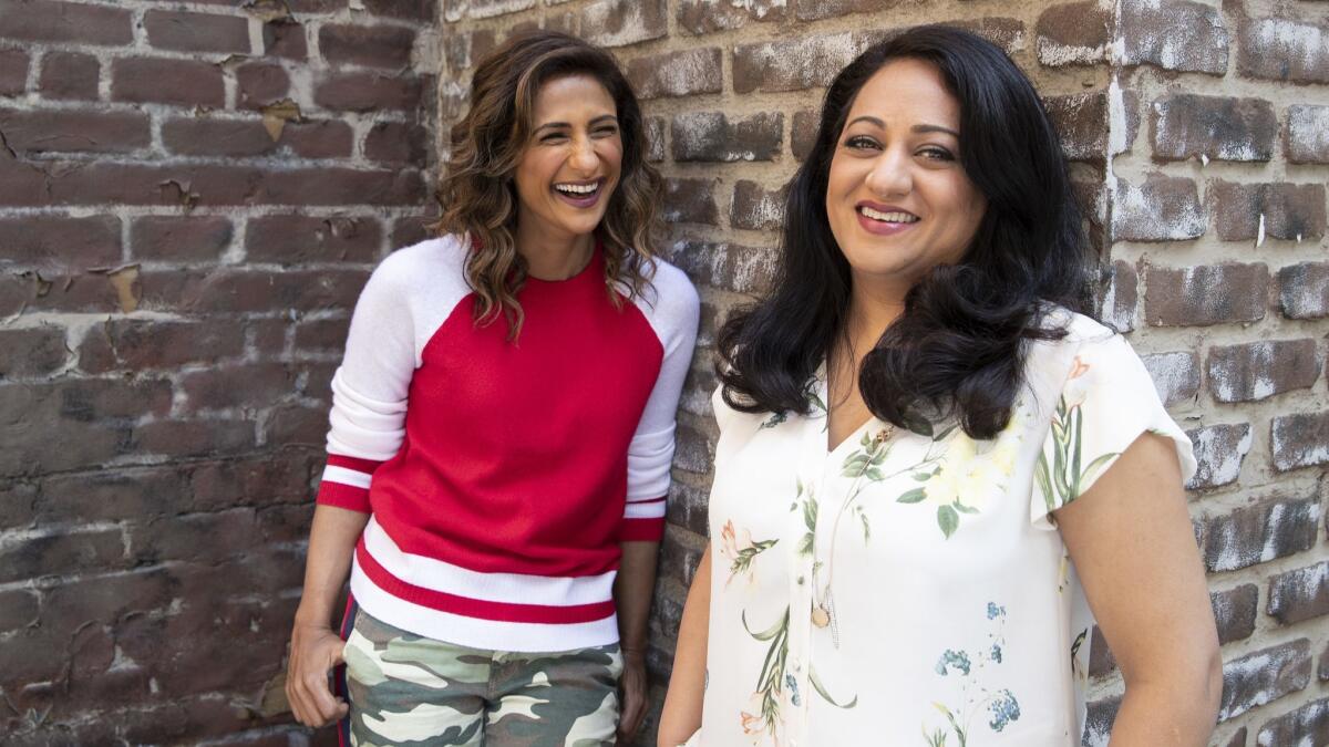 "I Feel Bad" showrunner Aseem Batra, right, shares a laugh with series star Sarayu Blue, on the Universal lot in Universal City.