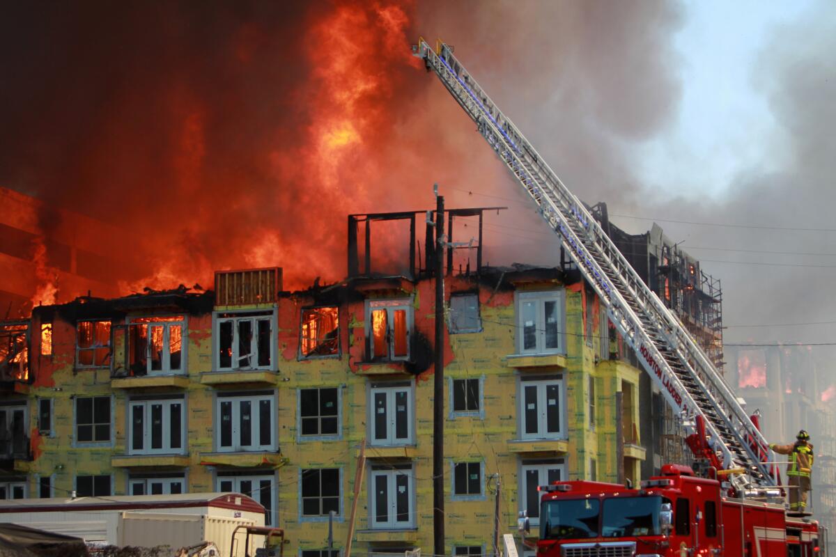 Houston firefighters respond to a five-alarm fire at a construction site in Houston.