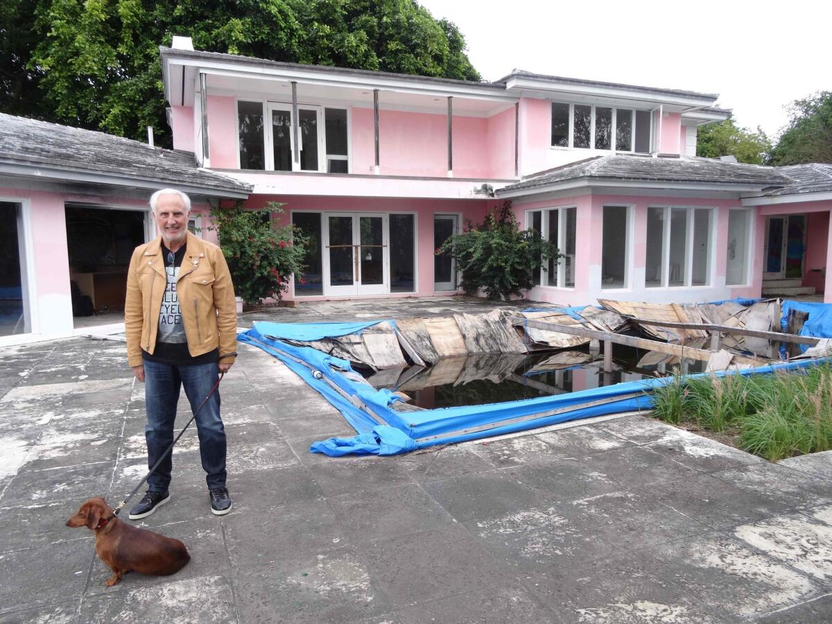 Christian de Berdouare stands near a Miami Beach home that once belonged to notorious Colombian drug lord Pablo Escobar.