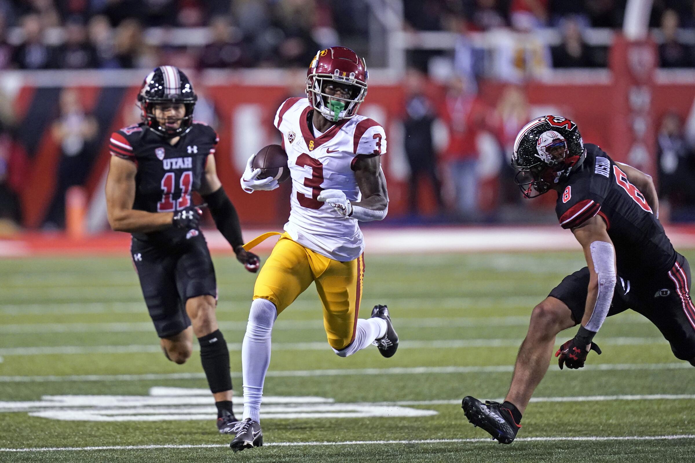 USC wide receiver Jordan Addison carries the ball after making a catch during the Trojans' loss on Oct. 15.