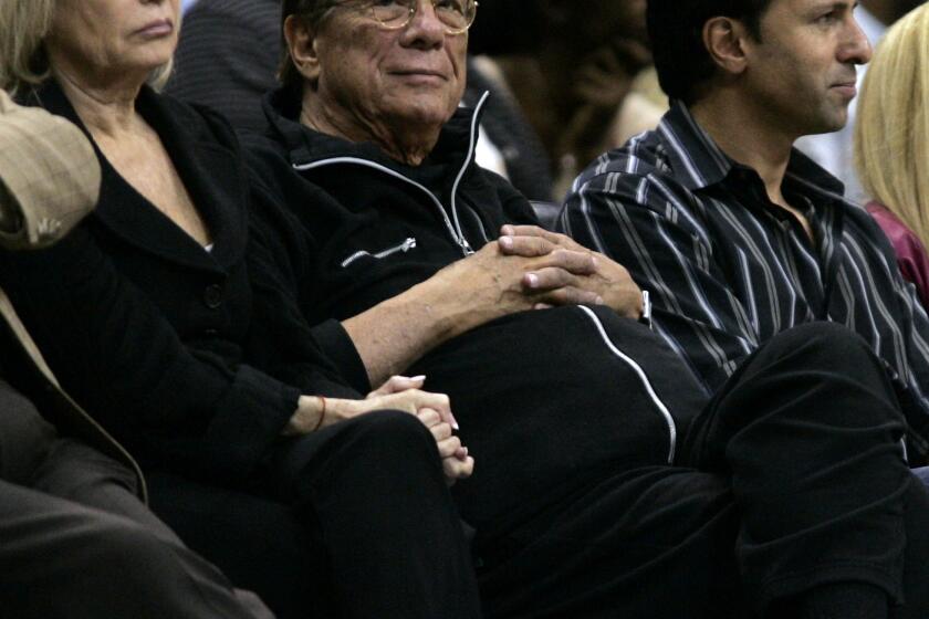 Rochelle Sterling (left) watches a preseason Clippers game in 2008 with her husband, Donald (center). Not shown: V Stiviano.