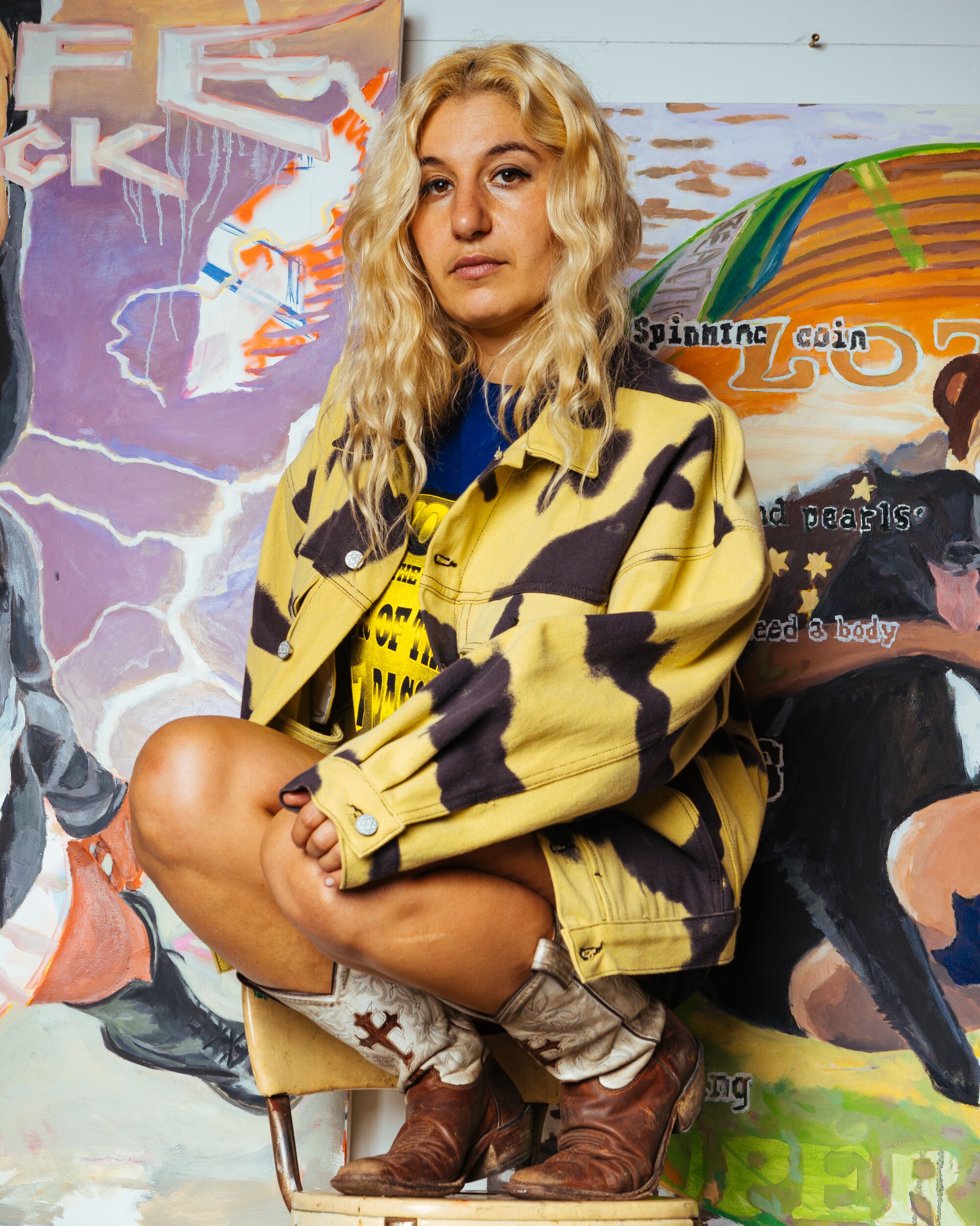 Photo of Sonya Sombreuil in a Come Tees denim jacket, Come Tees 'WHO AM I RAVER TEE' and vintage boots.