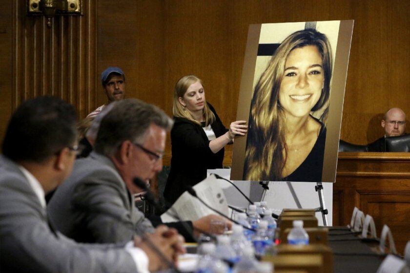A photo of murder victim Kate Steinle (R), allegedly killed at the hands of an undocumented immigrant in 2015, is placed on an easel as her father Jim Steinle (2nd L) prepares to testify about her murder at a hearing on U.S. immigration enforcement in Washington, D.C.