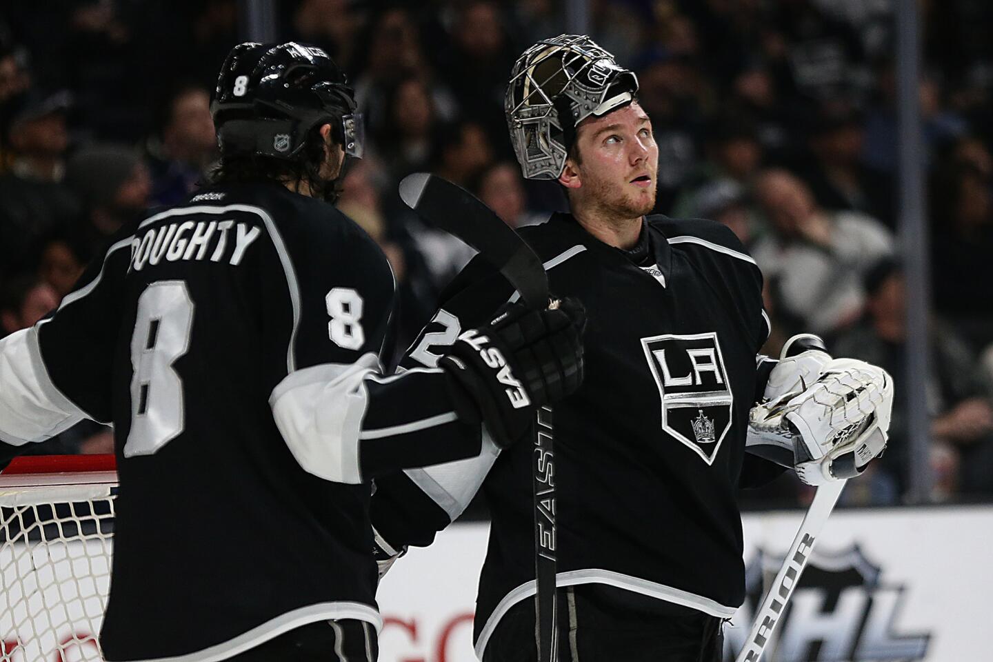 Kings goalie Jonathan Quick, right, talks with teammate Drew Doughty during a break in the action on Jan. 21, 2016.