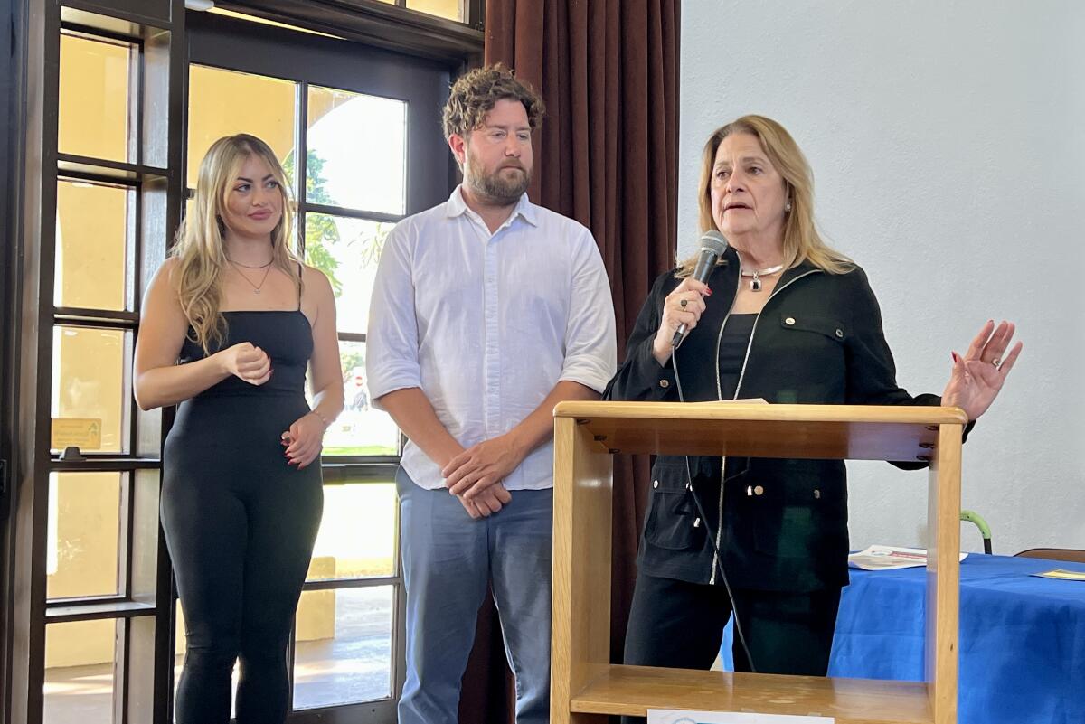Ann Kerr Bache (right), with volunteers Brooke Baginski and Rick Dagon, speaks about the 2023 La Jolla Christmas Parade.