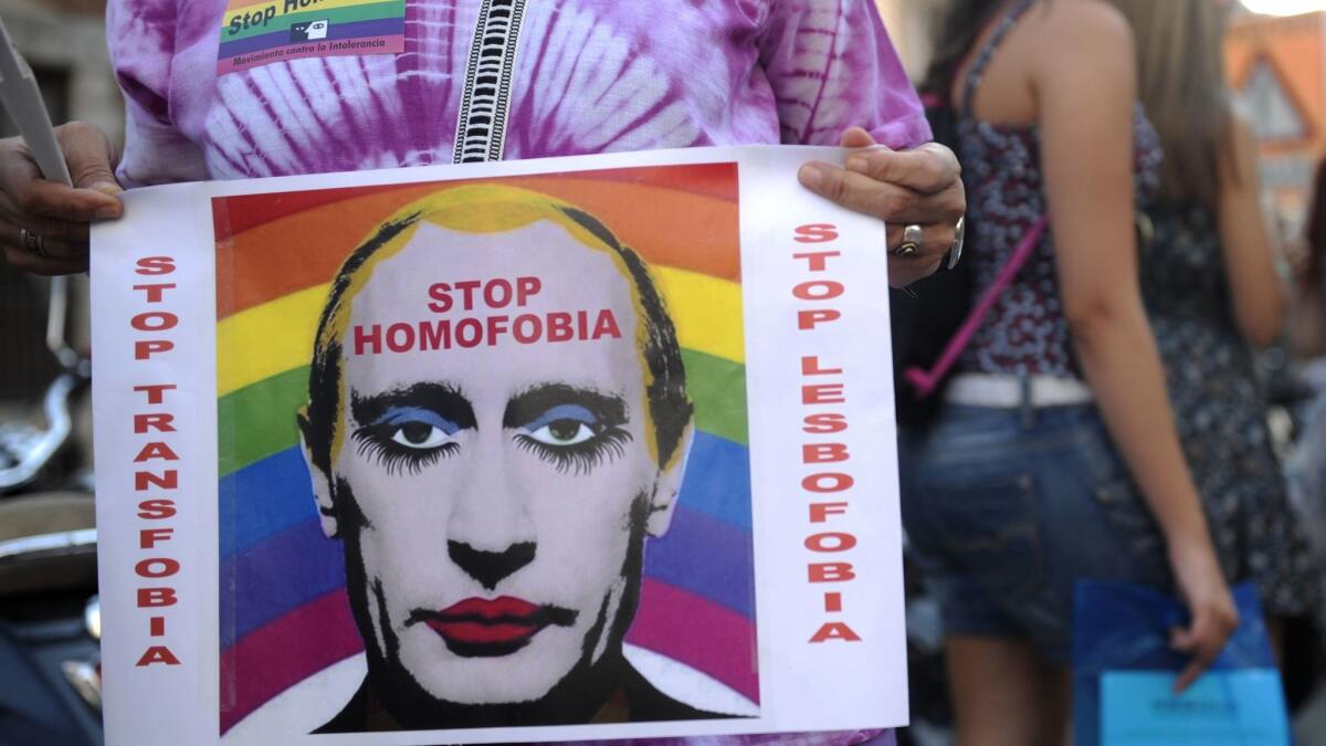 A demonstrator holds a poster depicting Russian President Vladimir Putin with makeup — an image that was recently banned in that country.