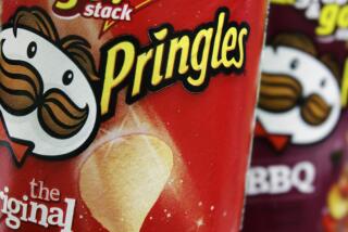 FILE - In this April 5, 2011 file photo, Pringles chips are seen in a posed photo at a West Bath, Maine grocery store. (AP Photo/Pat Wellenbach, File)