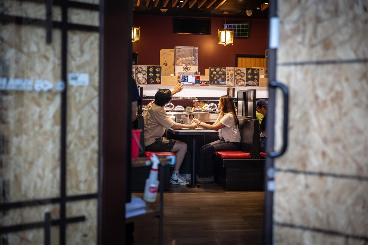Los Angeles, CA - June 17: People eat at Kura Sushi after being closed due to unrest after ICE immigration raids in L.A.