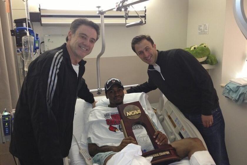 Kevin Ware, shown in the hospital with Louisville Coach Rick Pitino, left, and former assistant coach Richard Pitino, is resting comfortably in an Indianapolis hospital after surgery on his broken leg Sunday night.