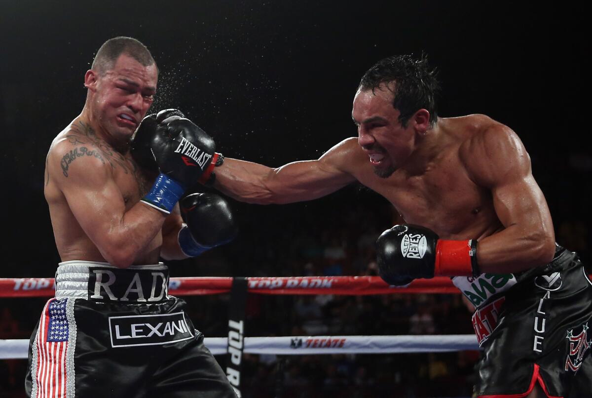 Juan Manuel Marquez, right, lands a right hand to the chin of Mike Alvarado at the Forum on May 17, 2014.
