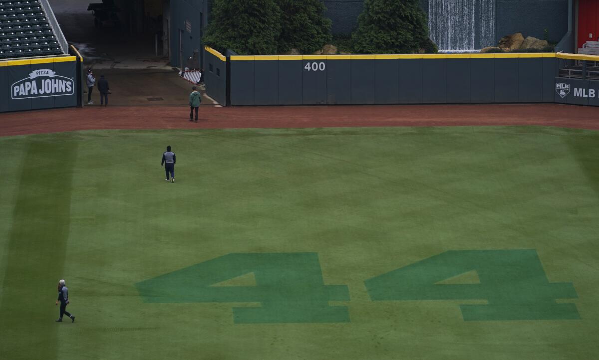 Hank Aaron's No. 44 is etched on the outfield grass at Truist Park.