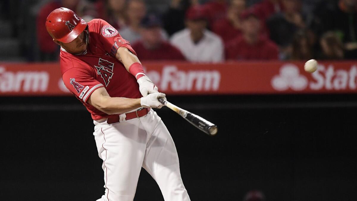 Angels center fielder Mike Trout hits a two-run home run against the Oakland Athletics on June 6.