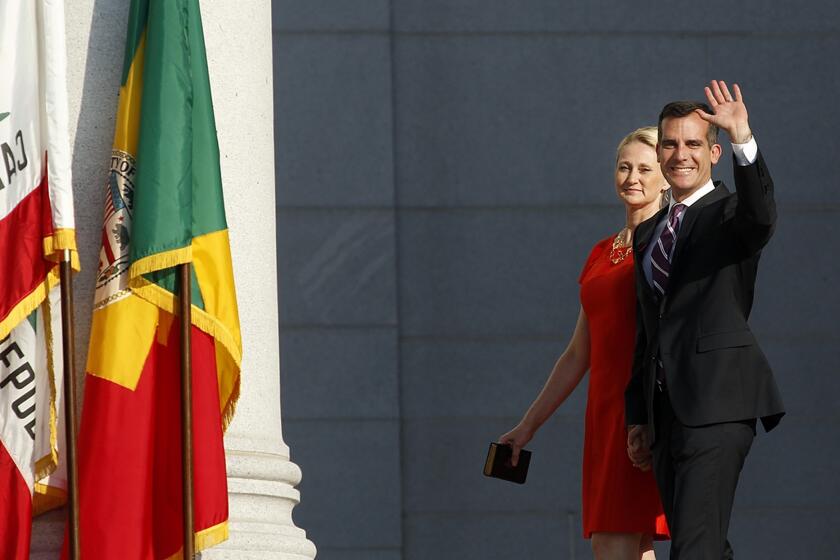 Mayor Eric Garcetti and his wife, Amy Wakeland, are introduced during his inauguration ceremony on the steps of City Hall in downtown Los Angeles.