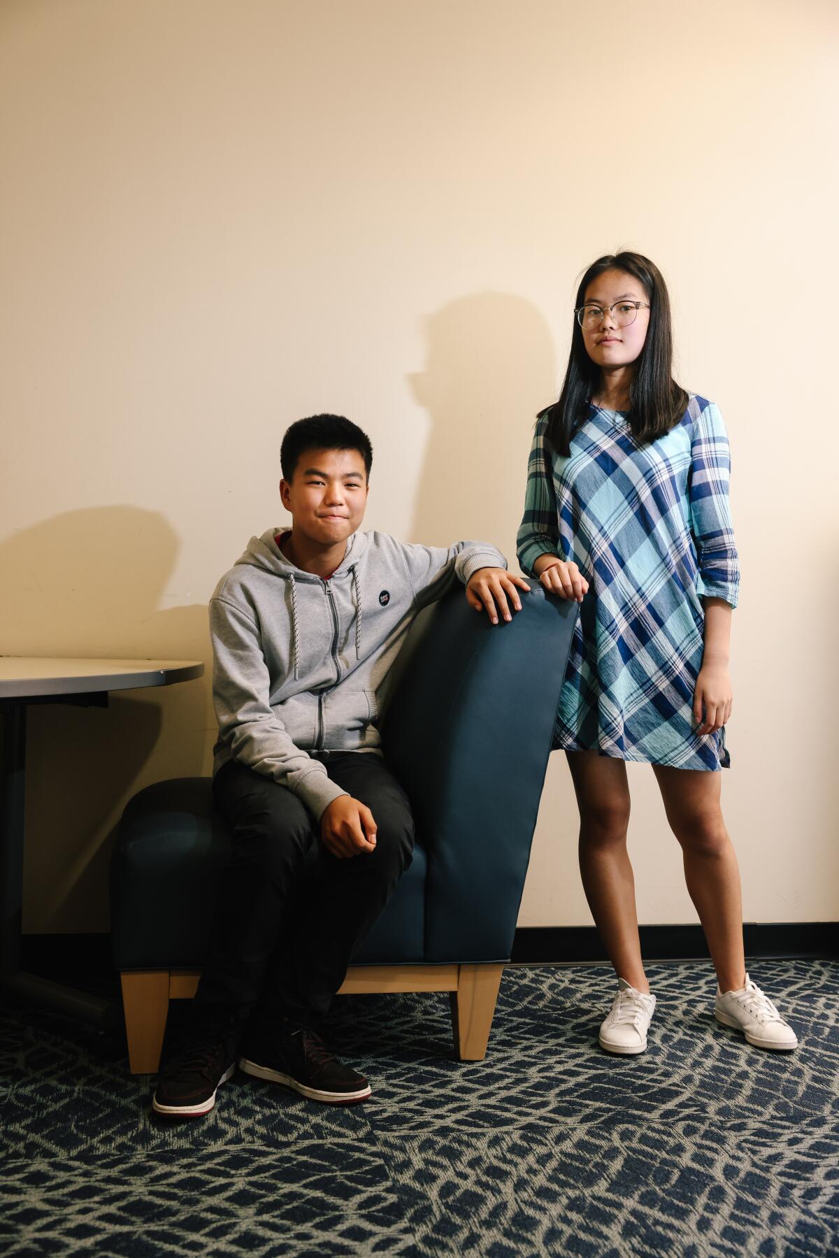 Antonio Chow sits for a portrait with his sister Angelina Chow.