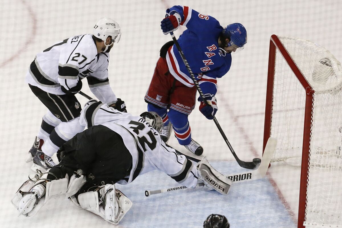 New York Rangers forward Mats Zuccarello, right, can't score past Kings defenseman Alec Martinez, left, and goalie Jonathan Quick during the first period of Game 3 of the Stanley Cup Final.