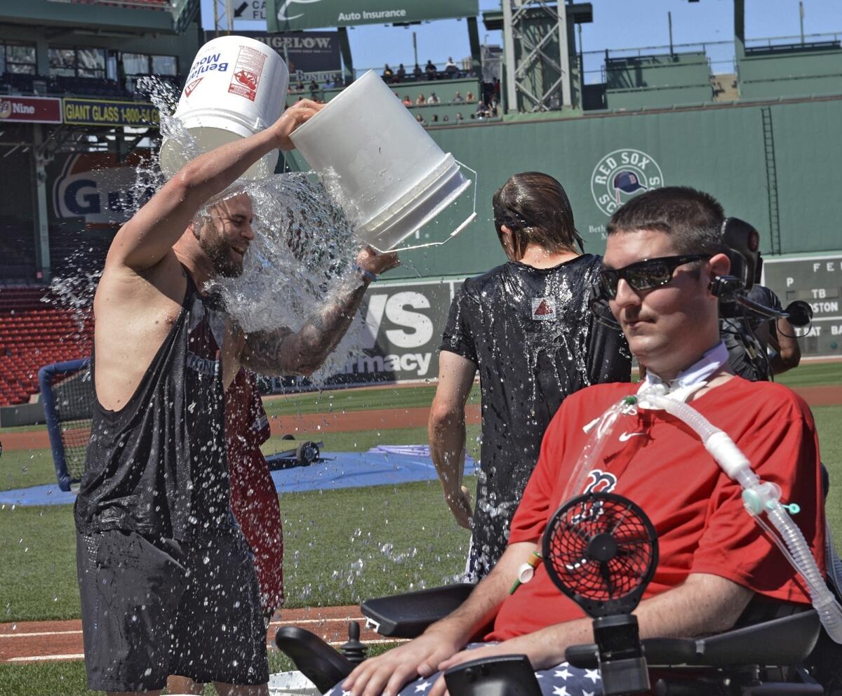 Boston Red Sox player Mike Napoli takes part in the relaunch of the Ice Bucket Challenge as former Boston College baseball player Pete Frates, right, looks on at Fenway Park in Boston on July 31, 2015.