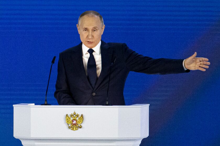 Russian President Vladimir Putin gestures as he gives his annual state of the nation address in Manezh, Moscow, Russia, Wednesday, April 21, 2021. Putin's state-of-the-nation speech comes amid a new surge in tensions with the West over a Russian troop buildup near the border with Ukraine and a hunger strike by jailed Russian opposition leader Alexei Navalny protesting a lack of adequate medical treatment in prison. (AP Photo/Alexander Zemlianichenko)