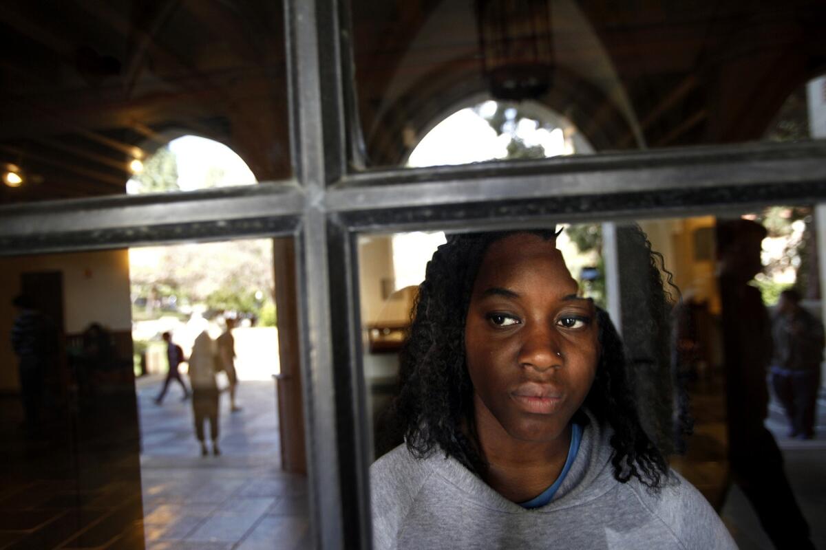 Student activist Janay Williams looks through a window from UCLA's Kerckhoff Hall. Williams is pushing for the school to require an undergraduate course dealing in topics of diversity.