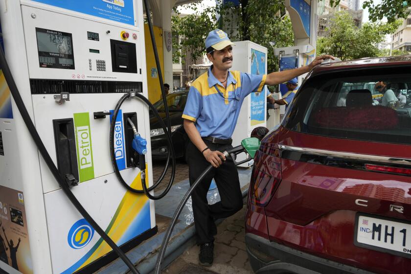 An employee of a Bharat petroleum fuel station fills petrol in a vehicle in Mumbai, India, Saturday, June 11, 2022. India and other Asian nations are becoming an increasingly vital source of oil revenues for Moscow as the U.S. and other Western countries cut their energy imports from Russia in line with sanctions over its war on Ukraine. (AP Photo/Rajanish kakade)