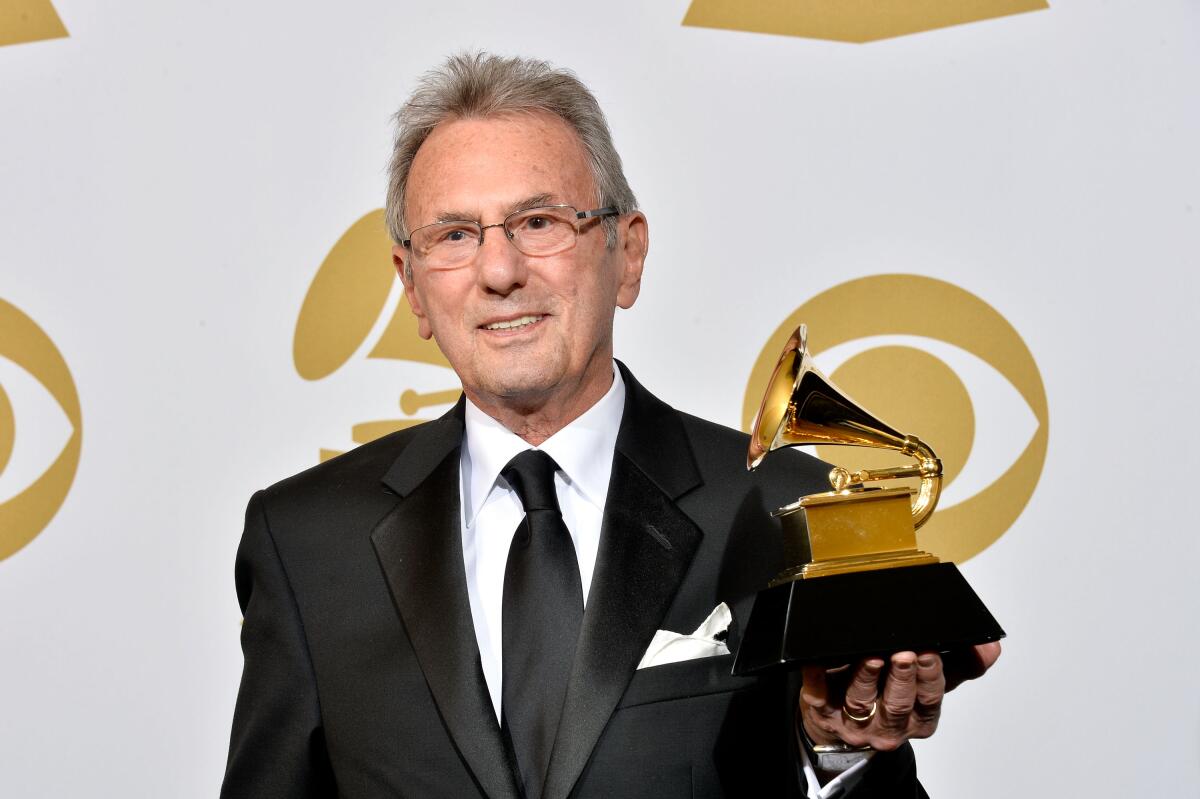 Al Schmitt holds one of his 23 Grammy Awards on Jan. 26, 2014.