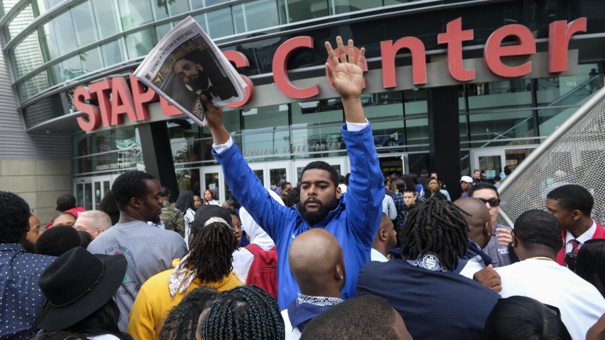 Fans of rapper Nipsey Hussle wait in line to attend a public memorial at Staples Center in Los Angeles, Thursday, April 11, 2019. Hussle was killed in a shooting outside his Marathon Clothing store in south Los Angeles on March 31. (AP Photo/Ringo H.W. Chiu)