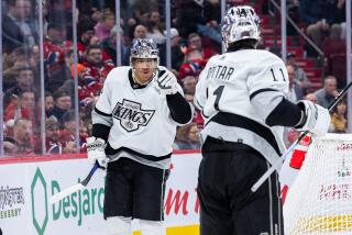 MONTREAL, CANADA - DECEMBER 7: Quinton Byfield #55 of the Los Angeles Kings (left) reacts.