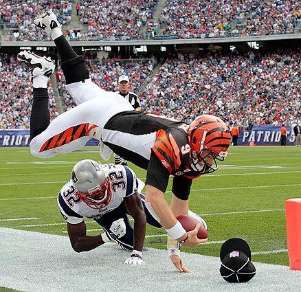 Cincinnati Bengals quarterback Carson Palmer is knocked out of bounds by New England Patriots cornerback Devin McCourty in the second half of their season-opening NFL game on Sunday in Foxborough, Mass.