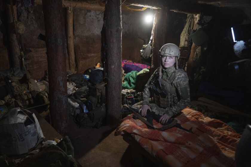 Ukrainian platoon commander Mariia rests in a trench in a position in the Donetsk region, Ukraine, Saturday, July 2, 2022. Ukrainian soldiers returning from the frontlines in eastern Ukraine’s Donbas region describe life during what has turned into a grueling war of attrition as apocalyptic. Mariia, 41, said that front-line conditions may vary depending on where a unit is positioned and how well supplied they are. (AP Photo/Efrem Lukatsky)