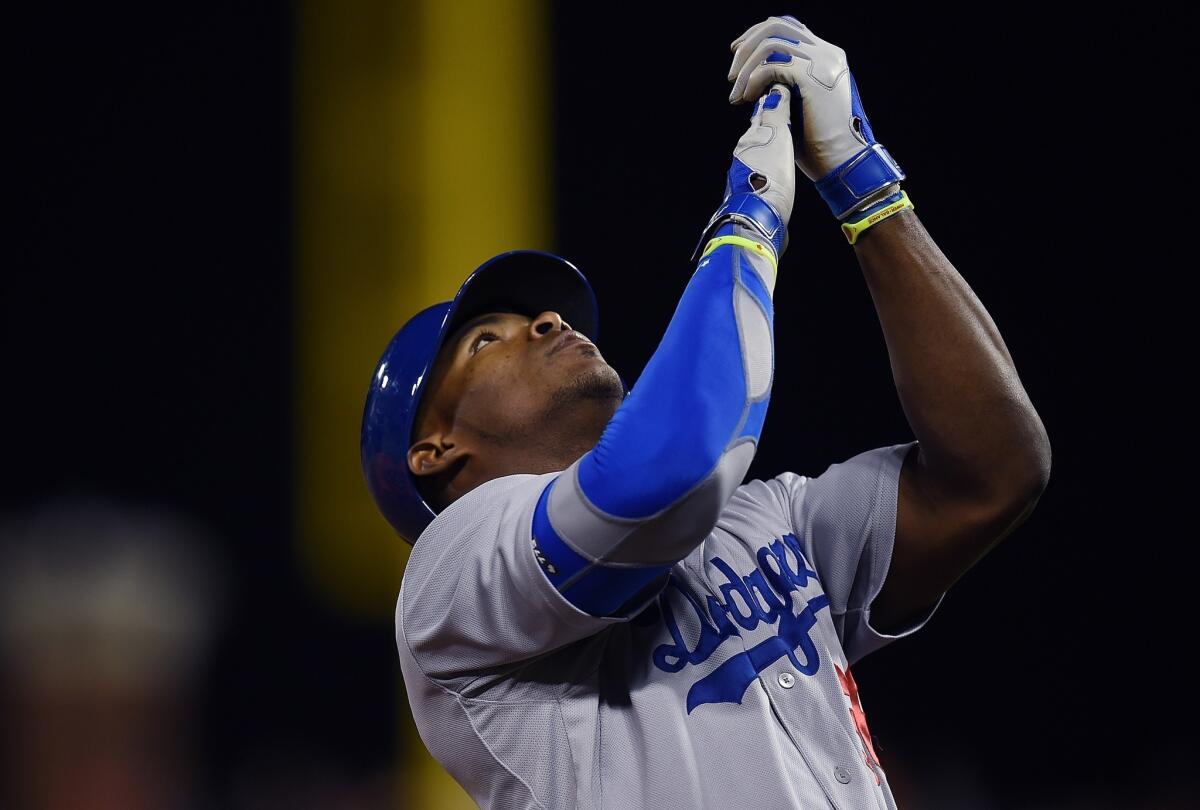 Yasiel Puig celebrates after hitting his third triple of the game against the San Francisco Giants on Friday at AT&T Park. The Dodgers beat the Giants, 8-1.