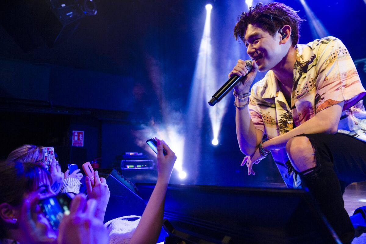 Eric Nam, host of "HWAITING," performs in Madrid in 2019.
