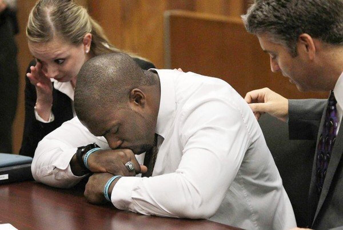 Brian Banks, with his attorneys, is overcome with emotion in the courtroom. When he heard from the alleged victim last year, “I stopped what I was doing and got down on my knees and prayed to God to help me play my cards right.”