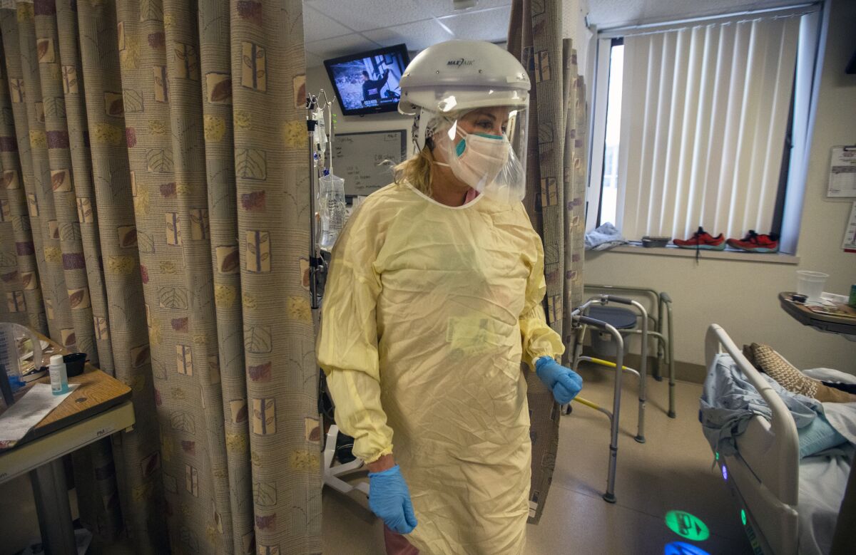 A nurse works inside a COVID-19 unit.