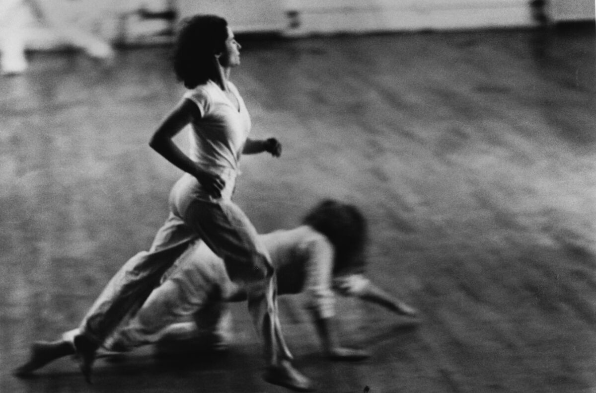 An image of one woman running and another crawling on the floor.