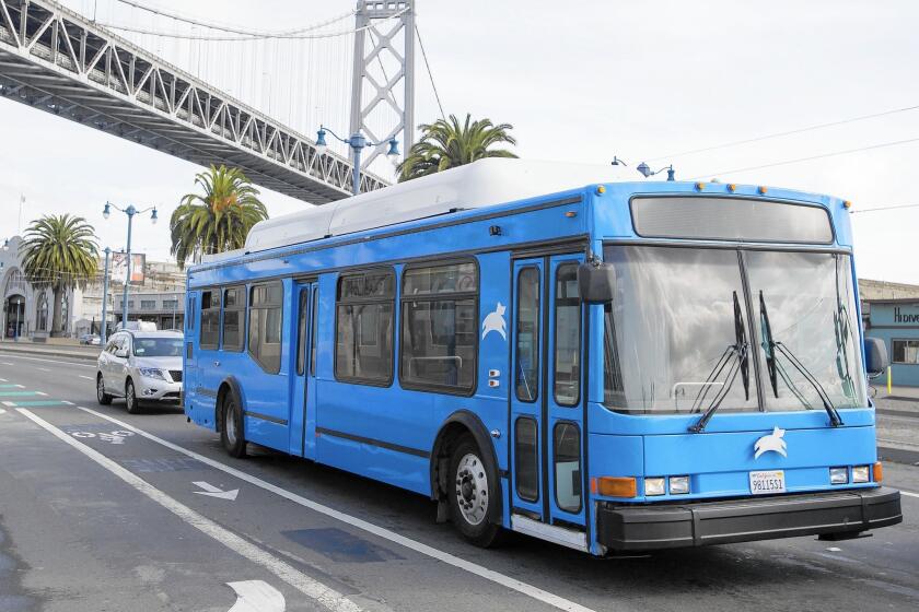 A Leap Transit bus, an alternative to the Muni network, drives under the Bay Bridge in San Francisco.