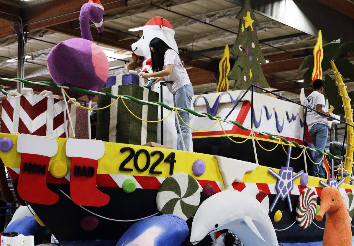 Volunteers work putting the final touches on Newport Beach's float.