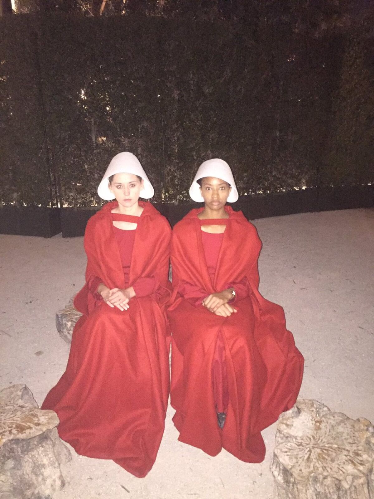 "Handmaids" await guests outside the Hulu party.
