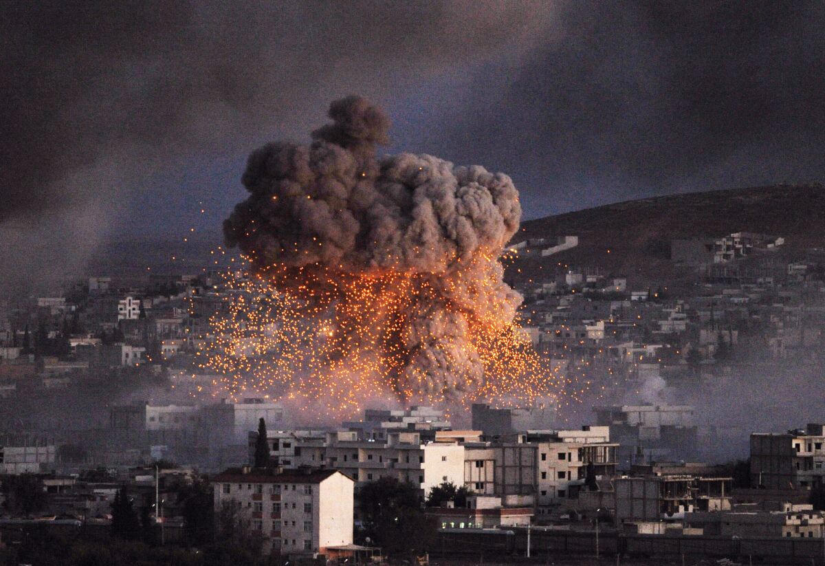 A suicide car bomb attack, reportedly by Islamic State militants, rocks a neighborhood in the Syrian city of Kobani.