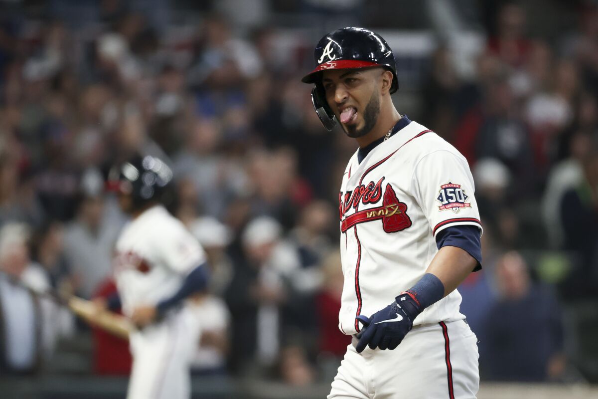 Atlanta Braves' Eddie Rosario reacts flying out to center field.
