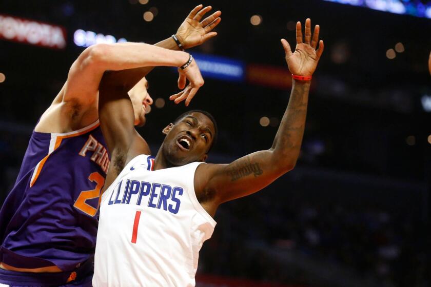 LOS ANGELES, CALIF. -- WEDNESDAY, DECEMBER 20, 2017: LA Clippers guard Jawun Evans (1) fights for a rebound with Phoenix Suns center Alex Len (21) in the first half at the Staples Center in Los Angeles, Calif., on Dec. 20, 2017. (Gary Coronado / Los Angeles Times)