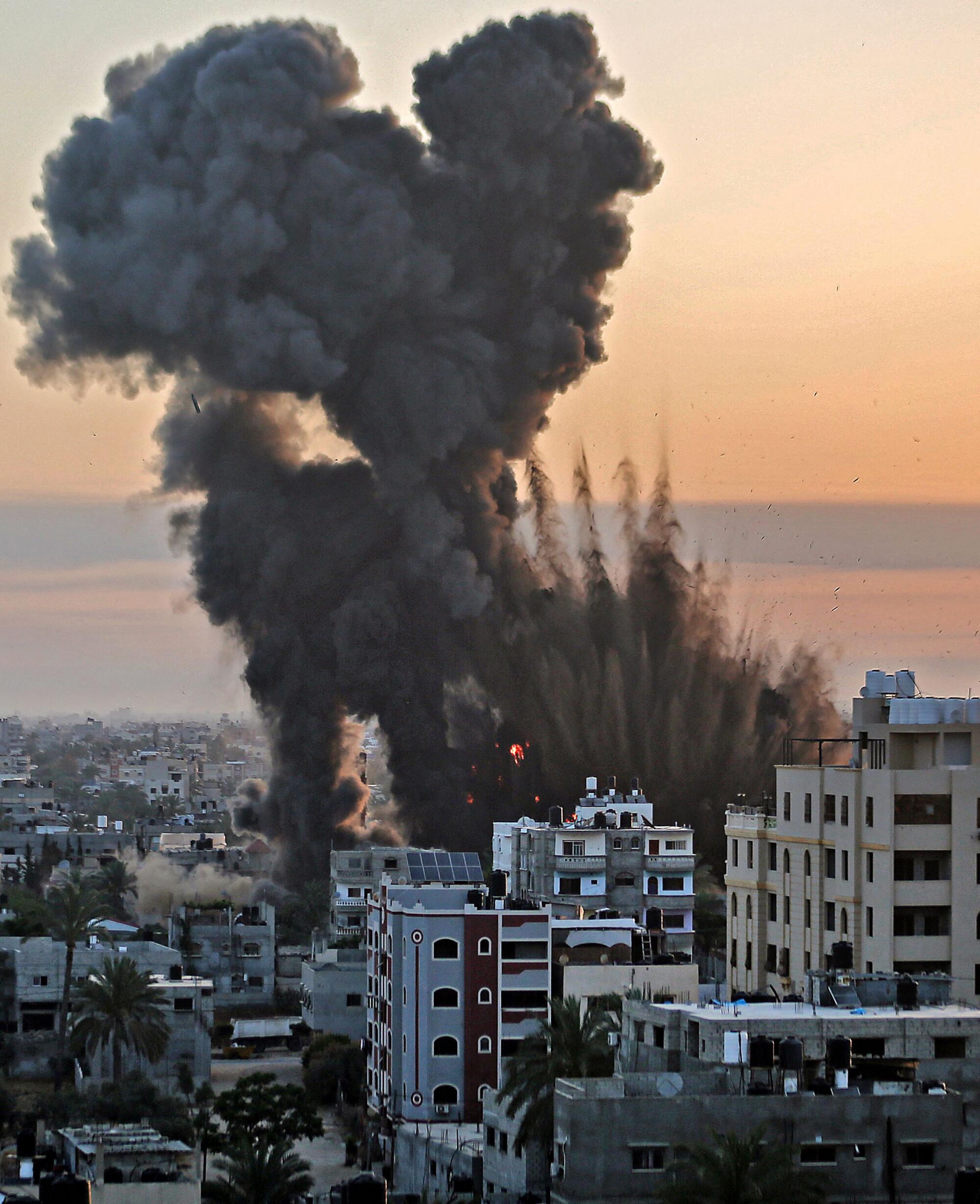 Black smoke billows among buildings