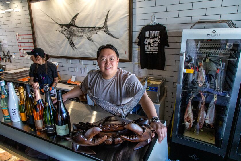 SHERMAN OAKS, CA - APRIL 7, 2023 - Portrait of Liwei Liao, the founder of The Joint Tea/Seafood market, posing behind display counter, with a Dry aging Chamber on the right, April 7, 2023, Sherman Oaks, CA. (Ricardo DeAratanha / Los Angeles Times)